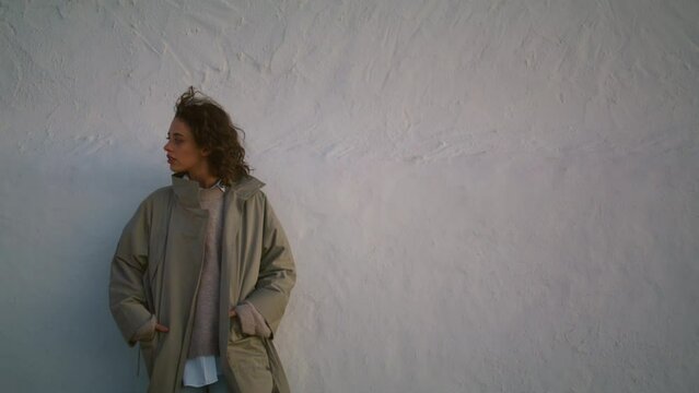 Worried woman lean street wall in evening. Thinking millennial girl walk alone.