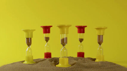 Hourglasses On A Yellow Background