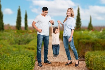 Fototapeta premium Beautiful young family posing on outdoor background