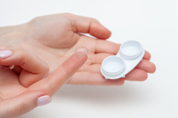 Contact Eye Lenses. Woman Hands Holding Contact Eye Lens. Woman Hands Holding White Eye lens Container. Beautiful Woman Fingers Holding Eye Lens Box