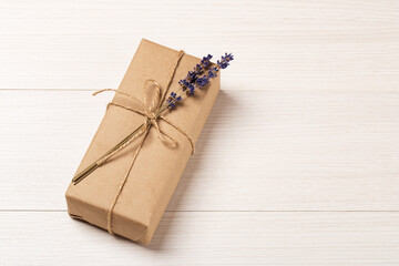 Craft gift box with lavender bouquet on a white wooden table. Eco-friendly concept. Rustic style. Romantic concept for presents