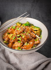 Delicious sweet chopping chicken rice, sesame seeds, sliced spring onions, broccoli, and vegetables. Asian food, Japanese food. Vertical photo