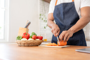 Obraz na płótnie Canvas Man preparing food in kitchen at home.