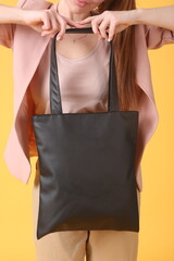 faux leather black shopper bag close up photo with model hand and face