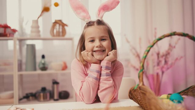 Portrait of little girl wearing rabbit ears, preparation for Easter holiday