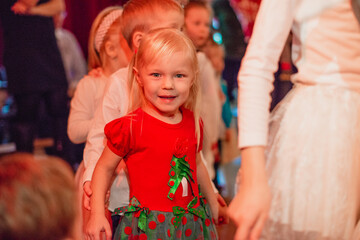 Smiling cute preschool girl at new year children's party