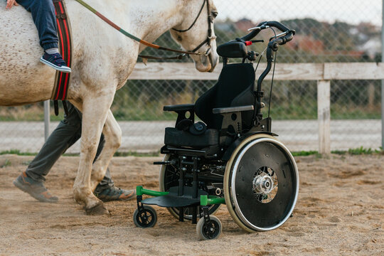 Wheelchair parked while a child has an equine therapy session.