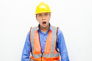 stressed over work concept illustrated by asian male construction worker in blue shirt, orange vest and yellow safety helmet with furious, mad, sad, angry expression. overworked concept