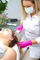 a girl in a beauty salon takes cosmetological procedures for the care and improvement of hair