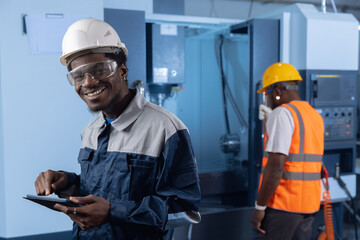 Professional african american engineer worker use tablet computer background CNC machine. Happy Industry portrait of manufacture