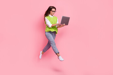 Full length photo of satisfied girl straight hair dressed green vest typing on laptop hurry at work isolated on pink color background
