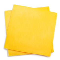 Square slices of meltable cheese, popular cheeseburger ingredient on white background.