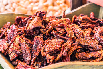 Dried tomatoes in the wooden bowl.