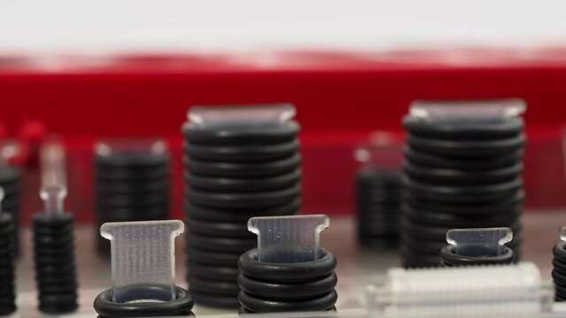 Rubber gaskets for plumbing. Hydraulic and pneumatic o-rings in black in different sizes on a white background.