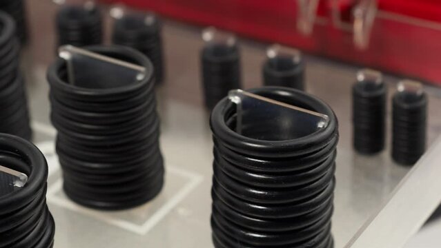 Rubber gaskets for plumbing. Hydraulic and pneumatic o-rings in black in different sizes on a white background.