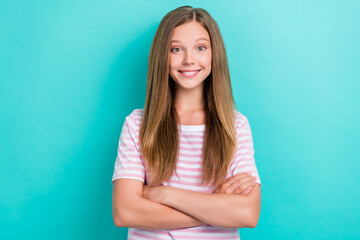 Portrait of satisfied glad young girl beaming smile crossed arms isolated on turquoise color...