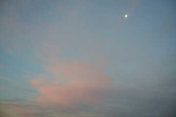 Pink sunset clouds and the moon