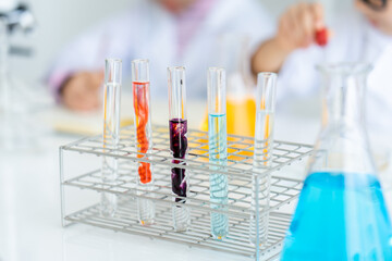 close up scientific test tube placed on the table in the science room. The colors are mixed in the test tube. doing chemistry experiments in elementary school