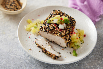 Fancy delicious poultry breaast fillet in pepper crust with fruity topping