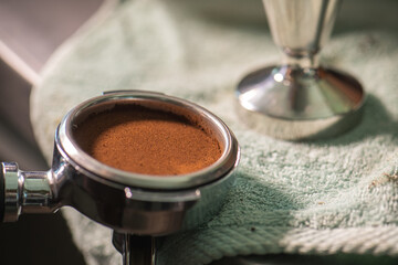 Tamped espresso finely ground coffee from coffee grinder grinds freshly roasted coffee beans with a...
