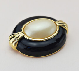 Old vintage brooch on beige background, accent retro jewelry for women
