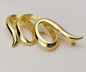 Old vintage brooch on beige background, accent retro jewelry for women