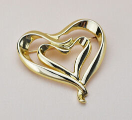 Old vintage brooch on beige background, accent retro jewelry for women
