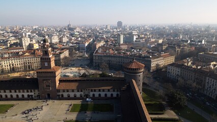 EUROPE, ITALY MILAN 2023 - Drone aerial view  from Sforza Castle in Sempione park with skyline of the city in downtown - Via Dante and Duomo cathedral 