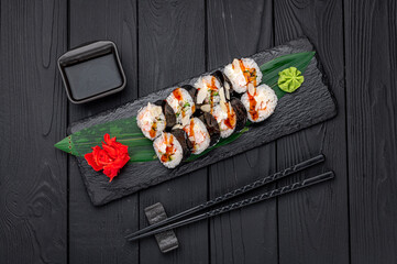 Sushi rolls with salmon, crab, shrimps and spicy sauce