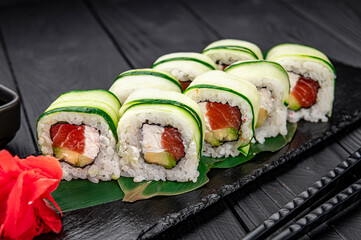 Sushi roll with salmon and cream cheese wrapped in cucumber