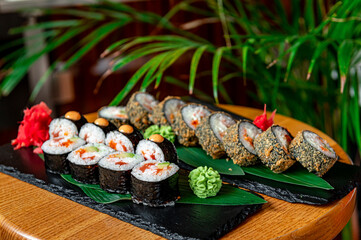 Big set of Asian food. Sushi and rolls on a dark background.