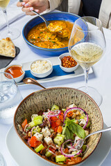 Italian food table with salad and pasta