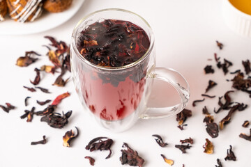 Red hibiscus tea from the petals of the Sudanese rose in a glass cup with a double bottom