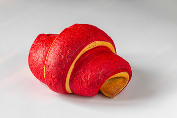 Red croissant close-up on a light background
