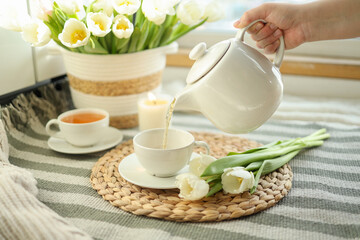 Tea is pouring into a cup from a teapot, beautiful aesthetic photo