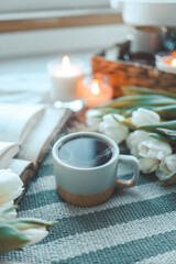 Fototapeta na wymiar Cup of tea, tulips and book, good morning