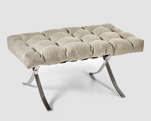 Soft grey-beige seat cushion on metal X-frame ottoman