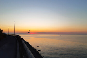 Naklejka na ściany i meble Panorama del mare all'alba sul tratto di strada incompiuta che va da Diano Marina ad Imperia, viaggi e paesaggi in Liguria