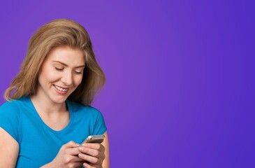 Smiling young woman posing with phone