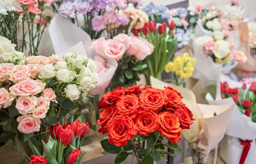 Flower shop concept. Different varieties fresh spring flowers in refrigerator room for flowers. Bouquets on shelf, florist business