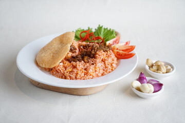Fototapeta na wymiar Nasi Goreng Merah or Red Fried rice typical dish from Makassar Indonesia