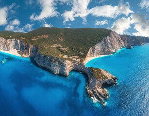 Aerial view of blue sea, mountains, sandy beach at sunny day in summer. Panorama. Porto Katsiki, Lefkada island, Greece. Beautiful landscape with sea coast, rocks, water, sky with clouds. Drone view - obrazy, fototapety, plakaty