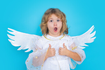 Valentine angel. Little cupid child. Kid angel with angels wings, isolated on blue studio background. Valentines day gift card.