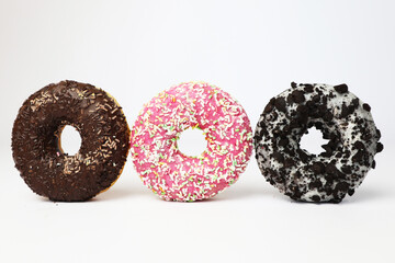 three donuts in a row on a white background top