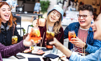 Trendy friends toasting drinks at fancy restaurant out side - Life style concept with young people...