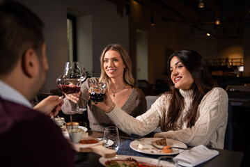 Happy business colleagues talking while eating lunch in a restaurant