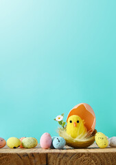 Easter eggs and yellow chick on a blue background. The minimal concept. © Belight
