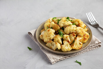 Homemade Roasted White Cauliflower on a Plate, side view. Copy space.