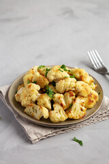Homemade Roasted White Cauliflower on a Plate, side view. Copy space.