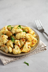 Homemade Roasted White Cauliflower on a Plate, side view.